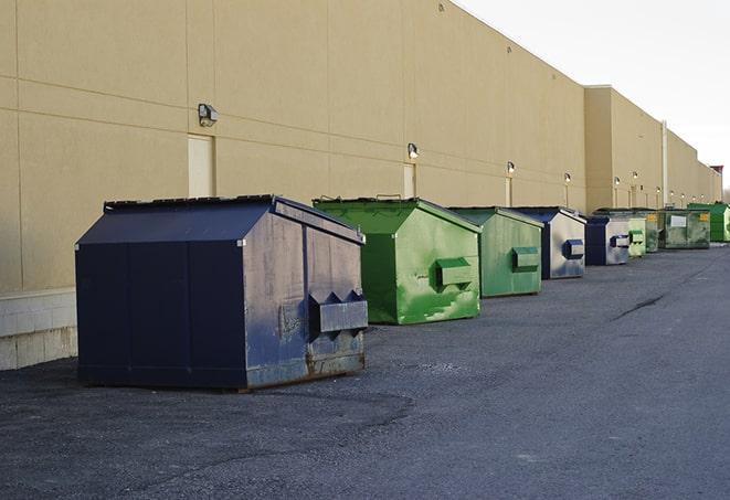 a row of construction dumpsters parked on a jobsite in Bluffton, IN